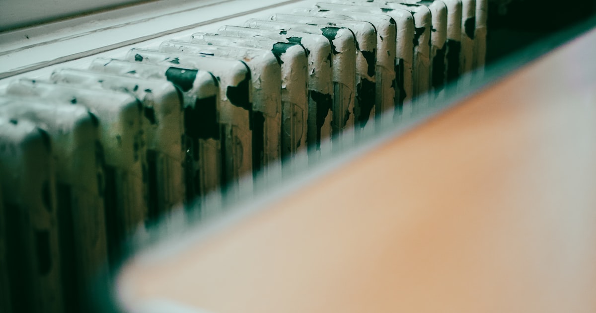 Close-up of a home radiator by a window